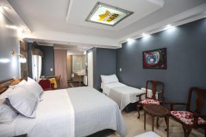 a hotel room with two beds and a bathroom at Hotel A&B Internacional in Buenos Aires