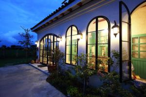 a house with arched windows and lights on it at Hanna Rosa Villa in Jialin