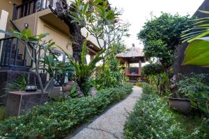 a garden with a path leading to a gazebo at Pondok Mimpi Tulamben by AGATA in Tulamben