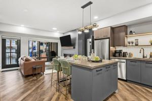 a large kitchen with a table and a living room at New Luxury 3 bedroom in Canmore