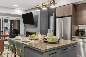 a kitchen with a table with a bowl of fruit on it at New Luxury 3 bedroom in Canmore