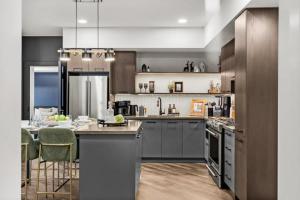 a large kitchen with stainless steel appliances and a table at New Luxury 3 bedroom in Canmore