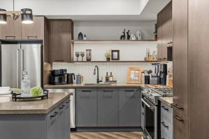 a large kitchen with stainless steel appliances and cabinets at New Luxury 3 bedroom in Canmore