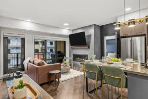 a kitchen and living room with a table and a couch at New Luxury 3 bedroom in Canmore +41 photos