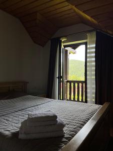 a bedroom with a bed with towels on it at Gray house in Yaremche