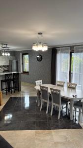 a dining room with a white table and chairs at Gray house in Yaremche