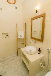 a bathroom with a sink and a mirror on the wall at Cafe San-Khara in Ahangama