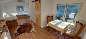 a room with a table and a bed and a window at Apartments AlpRoza in Zgornje Gorje +46 photos