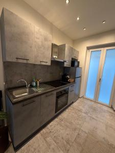 a kitchen with a sink and a counter top at R Apartment - Venaria in Venaria Reale
