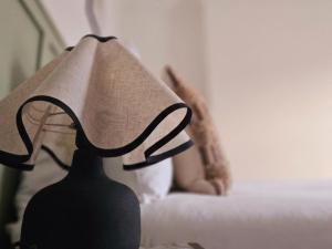 a lamp sitting on a table next to a bed at Saint Margaret's Guest House - Comfortable Rooms in a Quiet Area Close to the Heart of Poole - Free Parking & Fast Wifi in Poole