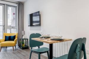 a dining room with a table and chairs at Once Upon a Tide - Stylish Apartment in the Heart of Poole in Poole