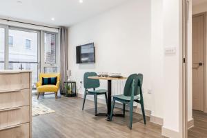 a dining room with a table and chairs at Once Upon a Tide - Stylish Apartment in the Heart of Poole in Poole +25 photos