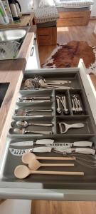 a drawer filled with lots of kitchen utensils at Apartments AlpRoza in Zgornje Gorje
