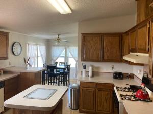 a kitchen with wooden cabinets and a stove top oven at High Plains Hideout 3 bedrooms 2 Baths in WaKeeney