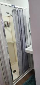 a shower curtain in a bathroom next to a sink at #7 Kipling Cottages Last Resort on Lake Michigan in Gladstone +20 photos