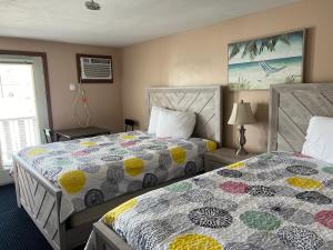 a bedroom with two beds and a window at Regal Inn Hampton Beach in Hampton