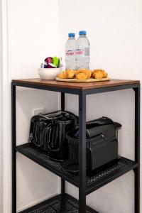 a table with bottles of water and bagels on it at Charming Getaway Near Paris in Alfortville