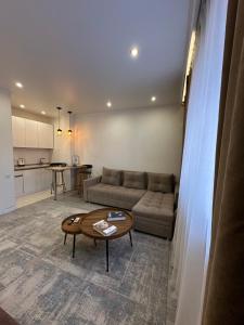 a living room with a couch and a table at Аблайхана 1 г in Kokshetau