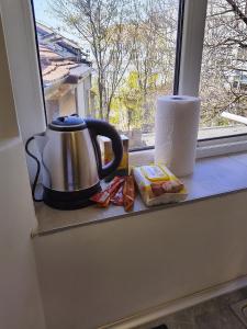 a tea kettle sitting on a window sill at City Centre Suits 3 in Varna City