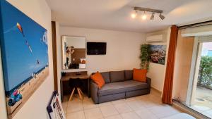 a living room with a couch and a table at Hôtel Le Maritime in Argelès-sur-Mer