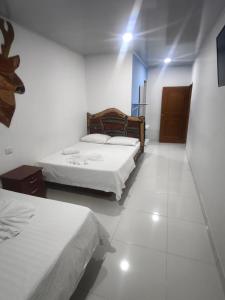 a room with two beds in a room at Hotel vacation Doradal in Doradal