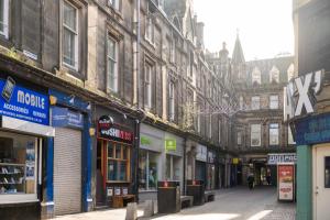 an empty city street with many shops and buildings at Lombard Hide Away in Inverness