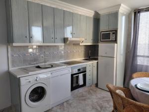 a kitchen with a washing machine and a washer at Sun and ocean in San Bartolomé