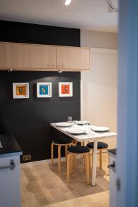 a kitchen with a table and two chairs and a counter at Lombard Hide Away in Inverness