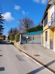 a fence on a street next to a building at Dimora Gundin in Govone