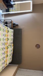 a room with a bed and two pillows at Comfy En-suite room in Gloucester
