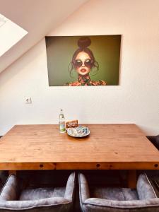 a wooden table with a picture of a woman on the wall at Apartments Yvonne Sigg in Rust +33 photos