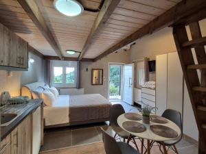 a bedroom with a bed and a table and chairs at Sogno 1 in Parga