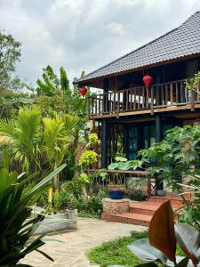 a house with a lot of plants in front of it at Lam Mountain Retreat Ông Lang in Phú Quốc