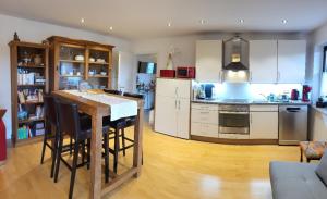 a kitchen with a table and chairs in a room at Lilie in Weilmünster