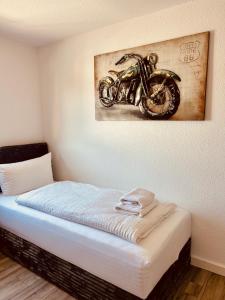a painting of a motorcycle hanging on a wall at Apartments Yvonne Sigg in Rust
