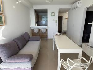 a living room with a couch and a table at "Ninfas" in Puerto Madryn