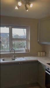 a kitchen with a sink and a window at Belfast Skyline Retreat - 3 Bedroom Apartment with Free Parking in Belfast +11 photos