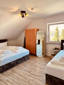 a room with two beds and a mirror at Apartments Yvonne Sigg in Rust