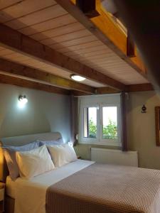 a bedroom with a bed and a window at Sogno 1 in Parga +31 photos