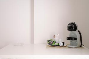a coffee machine sitting on a counter next to a plate at La Quiete in Scilla +27 photos