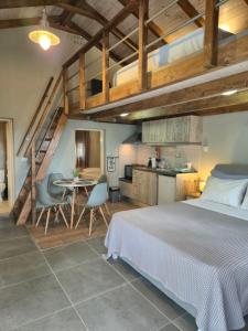 a bedroom with a bed and a table and chairs at Sogno 1 in Parga