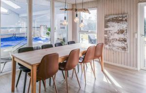 a dining room with a wooden table and chairs at 4 Bedroom Amazing Home In Ørsted in Ørsted