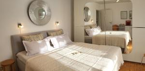 a hotel room with two beds and a mirror at Lilie in Weilmünster