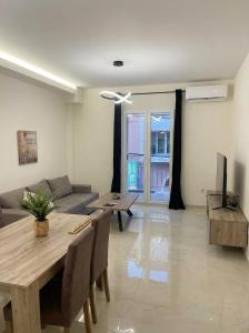a living room with a table and a couch at Ionian Port Suite in Ágios Rókkos
