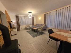 a living room with a couch and a table at Komfortowy Dom Całoroczny - sauna, jacuzzi, bilard in Tyłowo