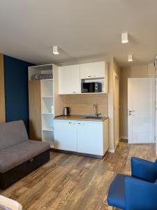 a living room with a couch and a kitchen at Hotel ADMIRAL POTOS THASSOS in Potos