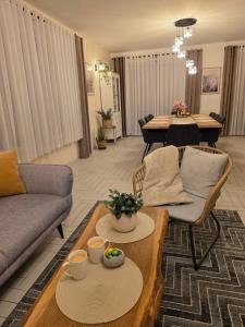 a living room with a couch and a table at Komfortowy Dom Całoroczny - sauna, jacuzzi, bilard in Tyłowo