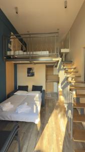 a bedroom with a bed and a staircase at Hotel ADMIRAL POTOS THASSOS in Potos