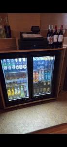 a refrigerator filled with bottles of water and drinks at The Devonshire House Hotel-Free Parking in Liverpool