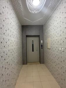 a hallway with a door in a room with tiles at رفاه in Medina +5 photos